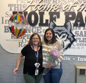 Mrs. Chimis and Mrs. Fagan receiving the 54 Blue Apple Award